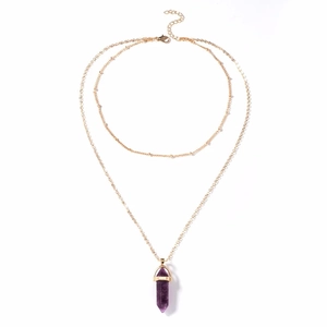 Detail of double-layer gold chain necklace with a purple hexagonal crystal stone pendant