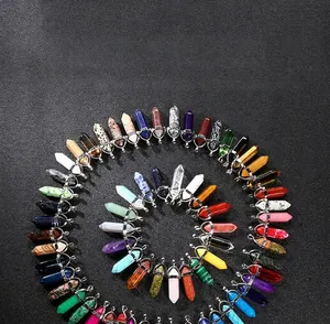 Detailed overhead view of hexagonal quartz point pendants in various crystal colors