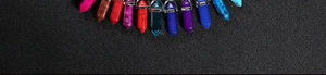 Detailed row of colorful hexagonal crystal quartz point pendants on a black background