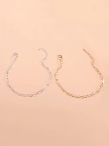 Close-up of gold and silver hollow heart chain bracelets with lobster clasps
