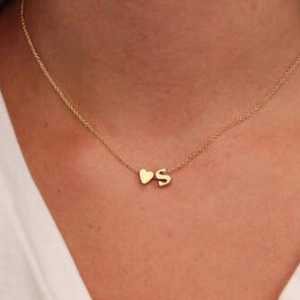 Elegant gold heart pendant necklace with initial S on a delicate clavicle chain for women