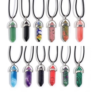 Set of 12 hexagonal crystal pillar pendants with black leather cords on white background