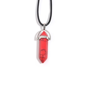 Macro view of red hexagonal crystal pendant with black cord and silver metal clasp