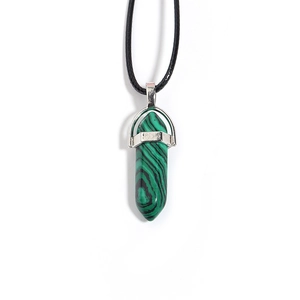 Detail of green malachite hexagonal prism pendant with silver clasp on black cord necklace