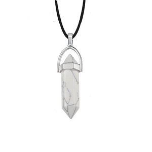 Macro detail of hexagonal white marble stone pendant on a black cord necklace