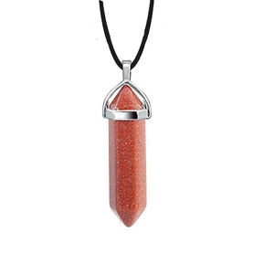 Macro detail of hexagonal red goldstone pendant with silver clasp and black cord necklace