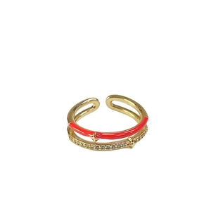 Double-layered gold ring with red enamel stars and sparkling cubic zirconia stones