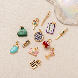 Set of 12 mixed enamel sport and fashion charms including camera and tennis racket