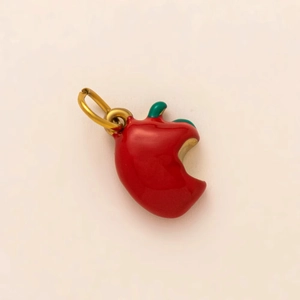 Macro shot of 18K gold plated red apple pendant with green stem and bite detail