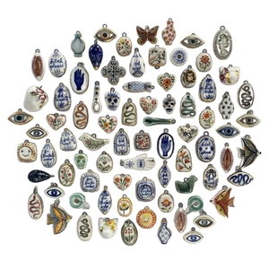 DIY ceramic pendants with gold edges, featuring evil eye and butterfly motifs