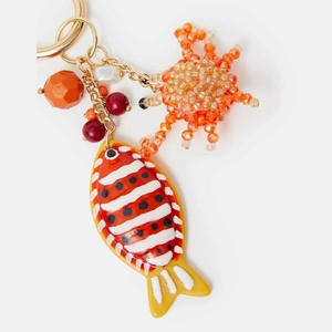 Detail of beaded fish and crab keychain charm with tropical sea-themed orange beads