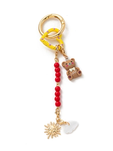 Detail of DIY keychain with LOVE brown bear, red beads, and golden sun pendants