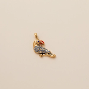 Exquisite gold bird pendant featuring vibrant blue rhinestones and red crystal beak accents