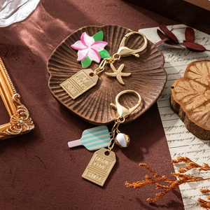Golden keychain with colorful summer beach charms and St Barts Hamptons nameplates