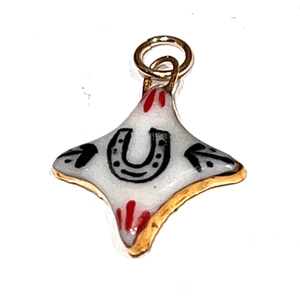 Détail du pendentif étoile en émail avec motif fer à cheval et bords dorés