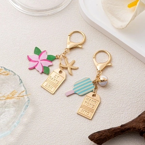 Vacation themed metal keychains with enamel flowers, rackets and tropical starfish charms