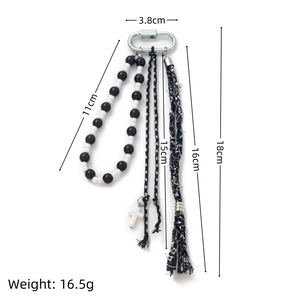 Detailed view of beaded keychain with cross charm and tassel showing 18cm length