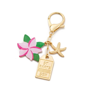 Detail of gold keychain with colorful frangipani flower and St Barts sea star charms