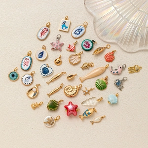 Collezione di ciondoli marini in smalto placcato oro 14k con stelle marine e conchiglie