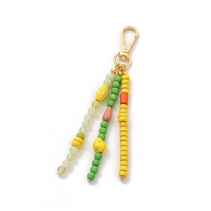 Close-up of vibrant beaded keychain pendant with colorful natural stones and gold metal clasp