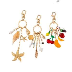 14K gold plated keychains featuring sea shells, pearls, and colorful acrylic fruit pendants