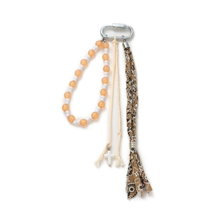 Bohemian style keychain with silver metal clip, orange beads and cross pendant on white background