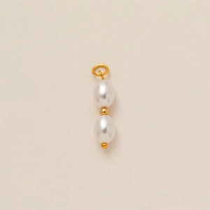 Detail of elegant gold-plated copper pendant with double white oval pearls for jewelry DIY