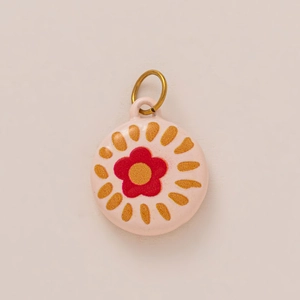 Detail of hand-painted pink floral ceramic pendant with gold ring and 18K gold plating