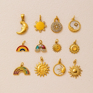 Collection of 12 celestial charms with sun, moon, and star motifs in 18K gold finish