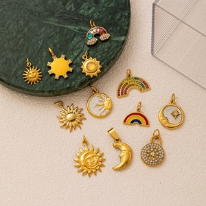 Golden celestial charm set with sun moon and rainbow pendants featuring zircons