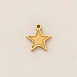 Detailed view of a gold star-shaped pendant with a matte textured center and smooth edges