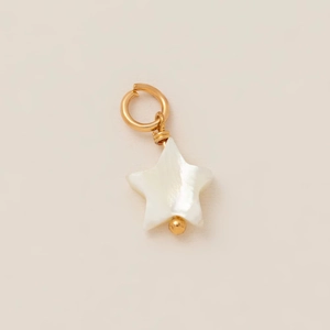 Detailed macro of a star shaped mother of pearl pendant with a gold plated metal loop