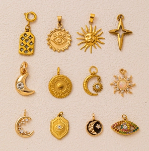 Macro view of 18k gold plated celestial pendants featuring sun, moon, and mystic eye motifs