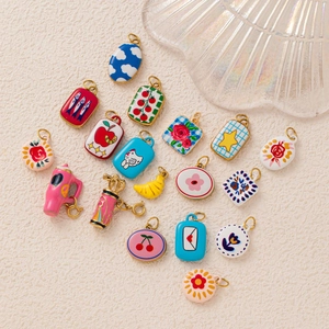 18K gold plated stainless steel DIY pendants in varied shapes on a cream textured background