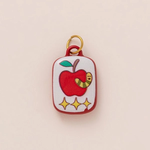 Detail of 18K gold plated fish can pendant featuring a cute caterpillar and apple design