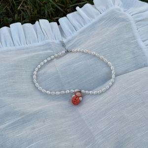 Handmade freshwater pearl necklace with red ladybug pendant and adjustable heart clasp