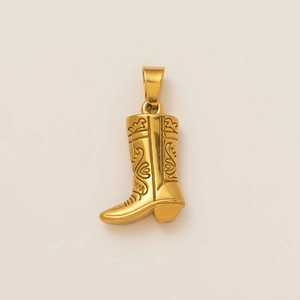 Macro shot of 18K gold-plated western cowboy boot pendant with engraved scroll patterns