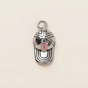 Detailed view of silver baseball cap pendant with pink heart and realistic stitch texture