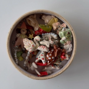 Hand-painted ceramic animal pendants including swan and mushroom in a round gift box