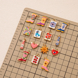 Colorful enamel western boot and heart charms set on a golden metal base