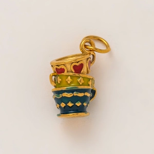 Close-up of a stack of three colorful enamel teacup charms in 18K gold plated steel