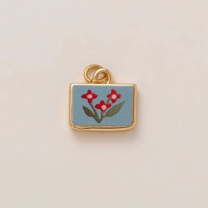 Golden rectangle charm pendant with blue matte enamel and red floral pattern