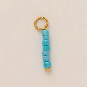 Detail of 18K gold-plated stainless steel ring with seven light blue pearlescent glass beads