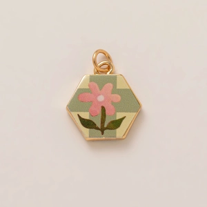 Hexagonal floral pendant featuring pink flower on green checkered pattern with gold rim