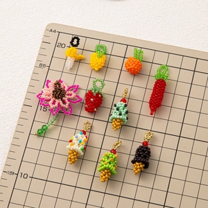 Handmade beaded charms featuring fruit, ice cream, and flower shapes for DIY accessories