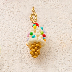 Detailed view of a handmade beaded ice cream cone charm with colorful seed beads