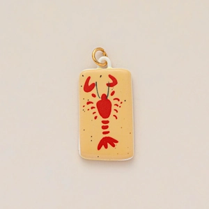 Detailed close-up of a rectangular ceramic pendant featuring a red lobster design with gold ring