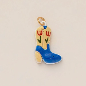 Detailed view of a cowboy boot pendant with blue tulip pattern and golden clasp