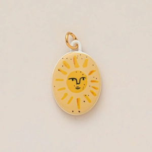 Detailed close-up of oval enamel pendant featuring a hand-painted yellow sun face illustration