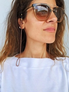 Detailed view of rose gold beaded eyewear chain with black anti-slip rubber loops